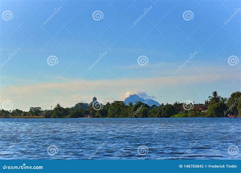 A Scenic View From The Sarawak River Of Mount Santubong In Kuching