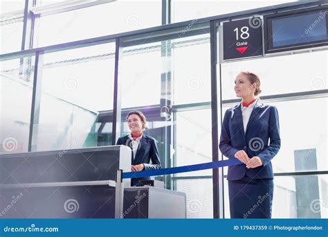 Portrait Of Young Beautiful Airport Staff Opening The Gate For Boarding