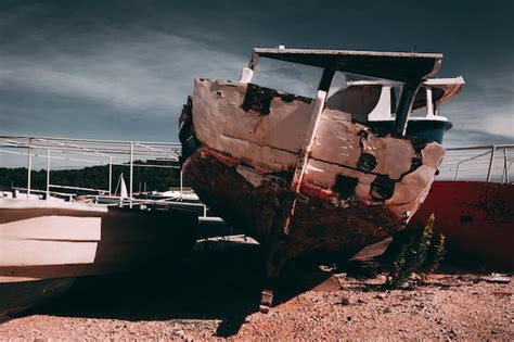 Premium Photo Abandoned Boat Moored At Shore Against Sky