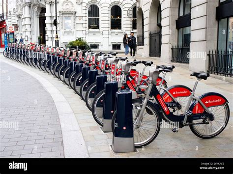 Santander bikes at a docking station Stock Photo - Alamy