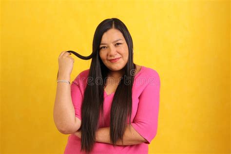Adult Forty Year Old Latina Woman Shows Between Her Fingers Her Long Healthy Shiny And Silky