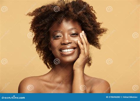 Smiling Dark Skinned Girl Touches Healthy Face Skin Stock Photo