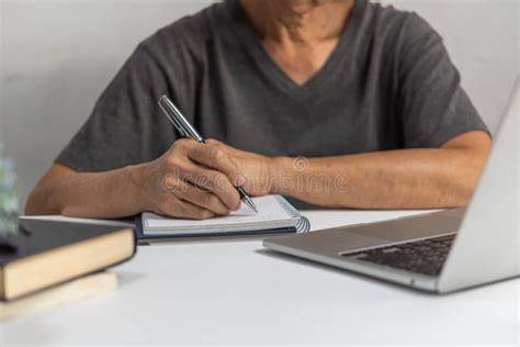 Woman Hands With Pen Writing On Notebook In The Officelearning