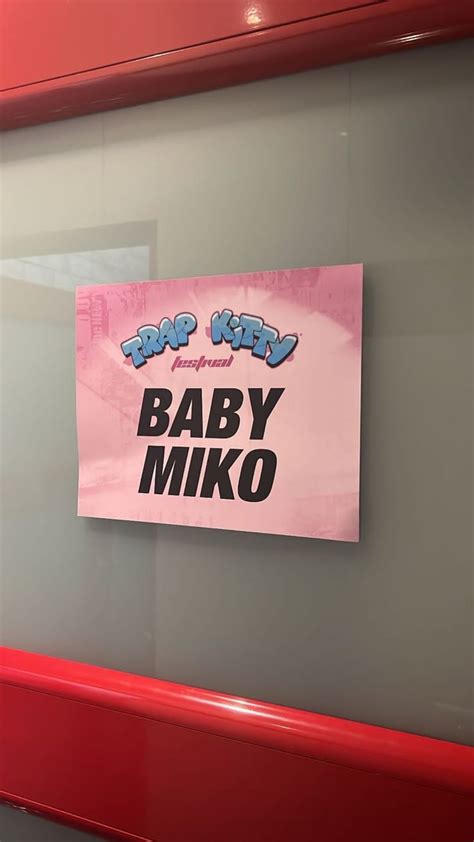 A Baby Miko Sign Hanging On The Side Of A Wall