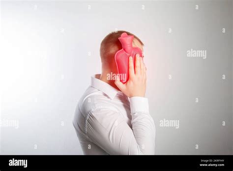 A Man Holds A Heating Pad With Hot Water Near His Cheek Toothache Infection Heat Treatment