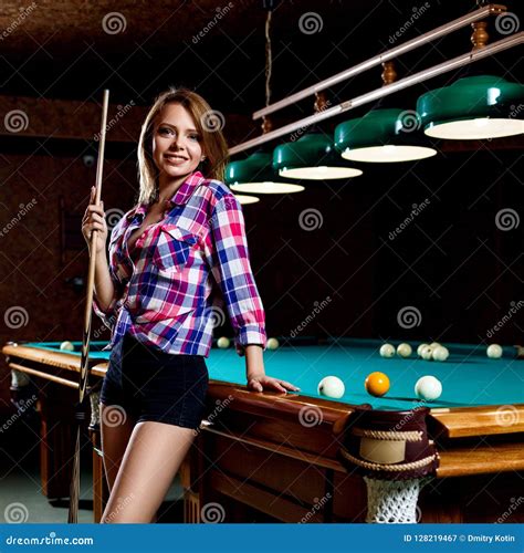 Beautiful Woman Stands Near Billiards Table With Cue Stock Image