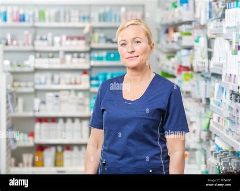 Female Pharmacist In Uniform Standing At Pharmacy Stock Photo - Alamy