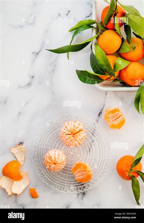 Mandarins With Leaves Whole And Peeled Stock Photo Alamy