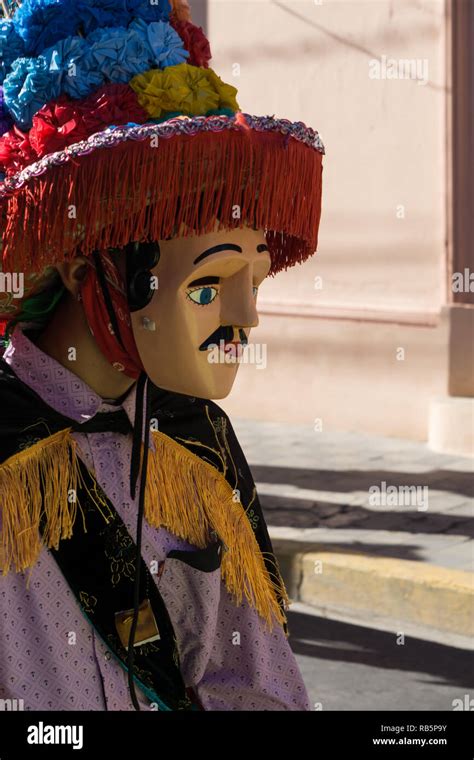 Granada, Nicaragua – February 15, 2017: People wearing traditional dress and colorful masks ...