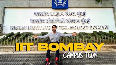 a man sitting on top of a sign in front of a building with the words it ...