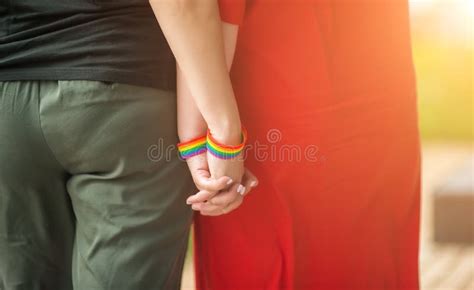 Hand Of Lgbt Women Holding Together With Rainbow Ribbon Symbol Concept