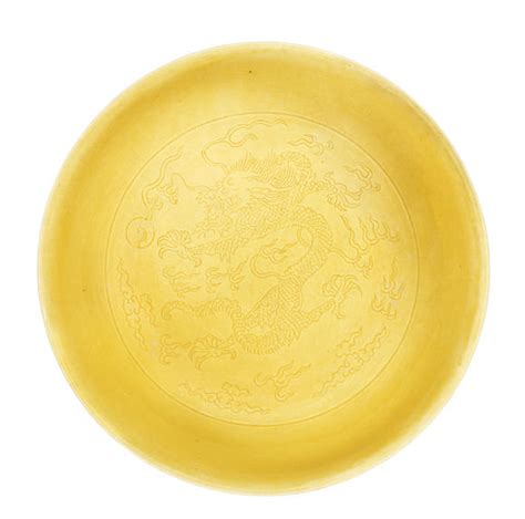 Bonhams A Yellow Glazed Incised Dragons Saucer Dish Daoguang Seal