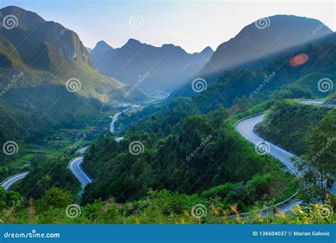 Motorbikers On Winding Roads Through Valleys And Karst Mountain Scenery