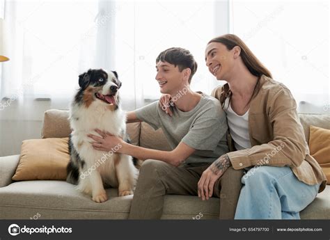 Overjoyed Long Haired Gay Man Casual Clothes Hugging Boyfriend Petting Stock Photo