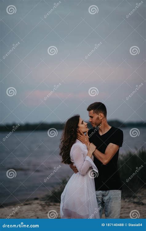 Couple Stands and Hugs on Beach Near Water Stock Photo - Image of male, embrace: 187140488