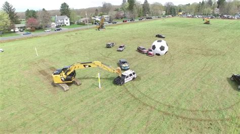 Cars Play a Giant Game of Soccer Using Heavy Duty Excavators as Goalies