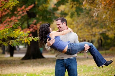 Guy Holding Girl In Arms Kissing