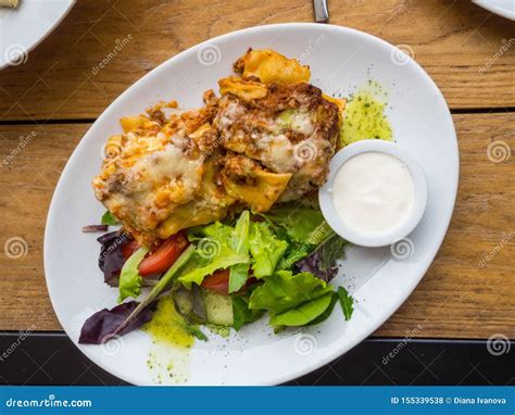 Tasty Serving Of Traditional Italian Lasagne With Spicy Tomato Based