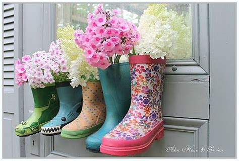 Four Colorful Rain Boots With Flowers In Them