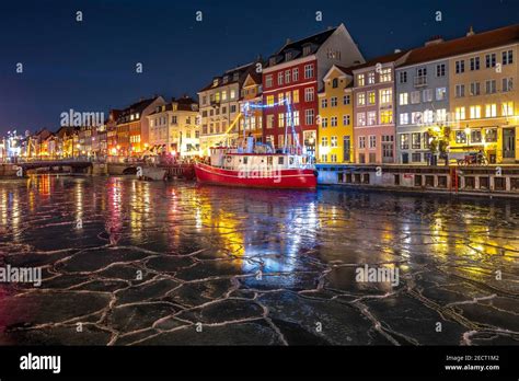 Copenhagen lights festival at night in Nyhavn with the frozen canal ...