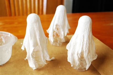 Diy Cheesecloth Ghosts In 2020 Diy Halloween Ghost Decorations