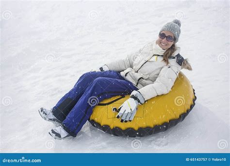 Woman Sledding Down A Hill On A Snow Tube Stock Image Image Of Jacket