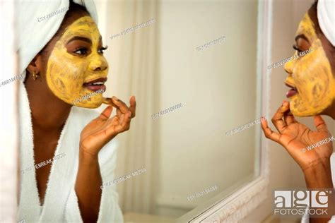 Happy African American Woman In Bathroom With Towel On Head Looking In