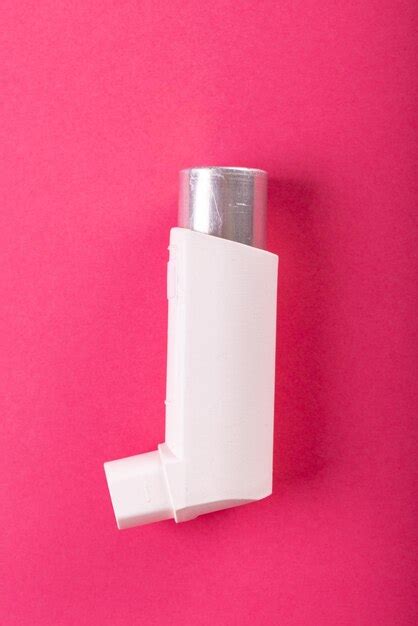 Premium Photo Close Up Of White Asthma Inhaler Isolated Against Pink