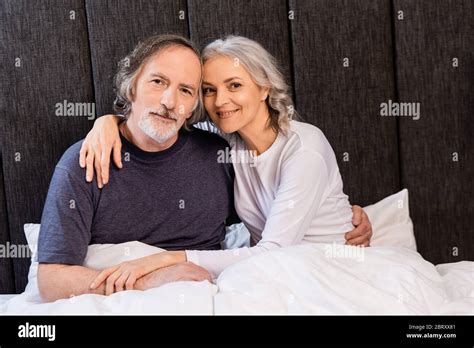 Cheerful Mature Couple Hugging And Smiling In Bed Stock Photo Alamy