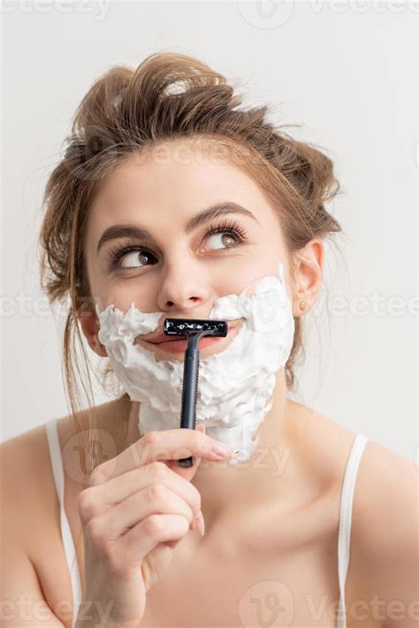 Woman shaving face with razor 22429633 Stock Photo at Vecteezy