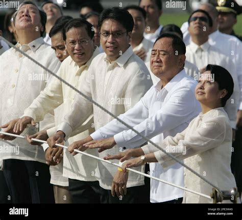 Philippine President Gloria Macapagala Arroyo Right Pulls A Cord With