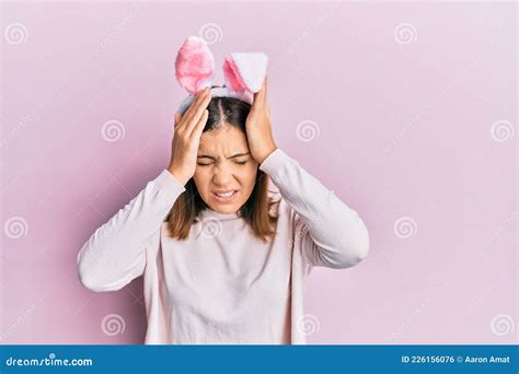 Young Beautiful Woman Wearing Cute Easter Bunny Ears Suffering From