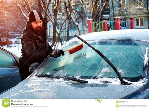 Man Cleans Snow From The Glass At Car Stock Photo Image Of Cold Fall