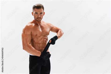 Man Athletic Bodybuilder Poses In Boxing Gloves With Nude Torso Abs In