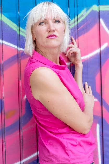 Premium Photo Portrait Of Woman Standing On Pink Indoors