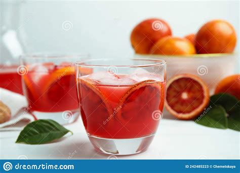 Tasty Sicilian Orange Juice With Ice Cubes And Fruits On White Table