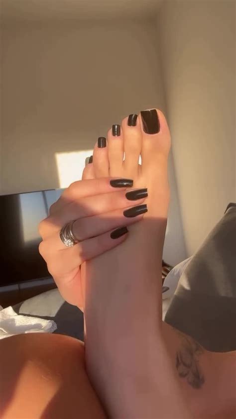 Sexy Amateur Model Touching Her Long Feet With Black Toe Nails In A Solo Feet