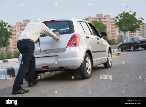 Businessman pushing his car Stock Photo - Alamy