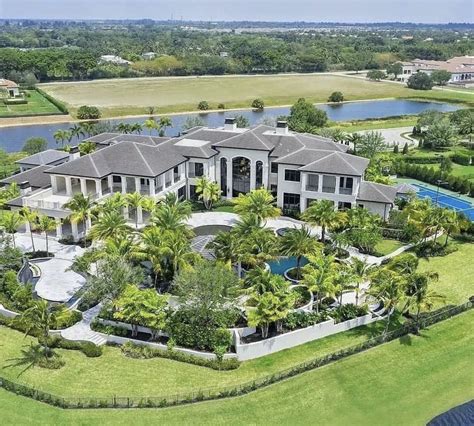 An Aerial View Of A Large House With Trees And Water