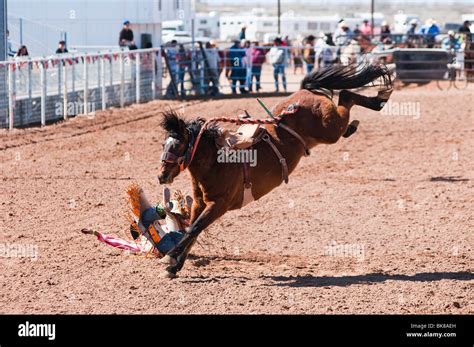 A Cowboy Competes In The Saddle Bronc Riding Event During The Oodham