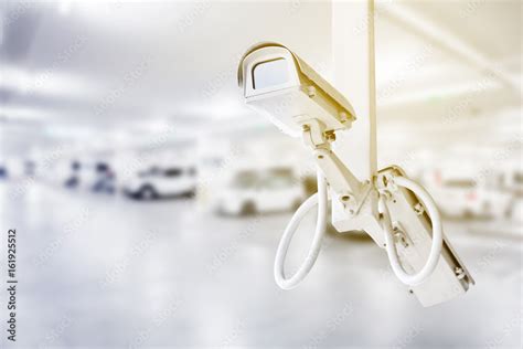 CCTV security camera with car parking background Stock Photo | Adobe Stock