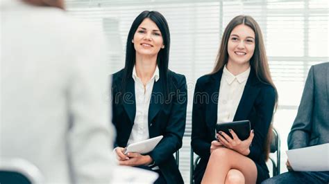 Employees Asking Questions At A Meeting With The Project Manage Stock