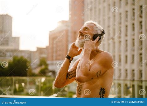 Shirtless Mature Man Listening Music With Headphones Outdoors Stock Image Image Of Street