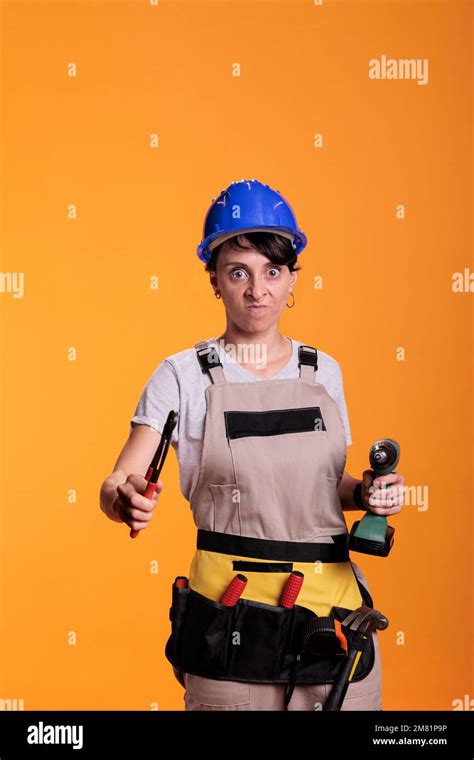 Mad Crazy Woman Contractor Posing With Renovating Tools Holding Pair