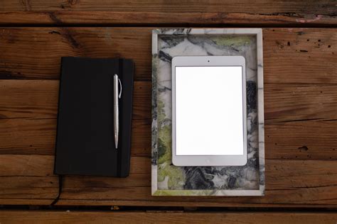 Black Pen on White Writing Spring Notebook Between White Ipad and White ...