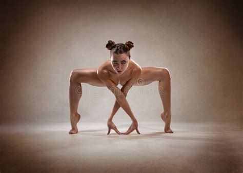 Beautiful Nude Fitness Girl With Great Figure Flexing Her Perfect Body In A Yoga Pose Stock