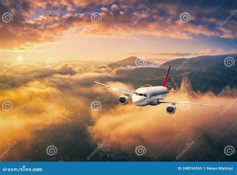 Airplane Is Flying Above The Clouds At Sunset In Summer Stock Image Image Of Travel Clouds