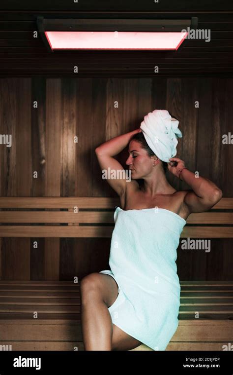 Woman Sitting And Relaxing In Hot Sauna Stock Photo Alamy
