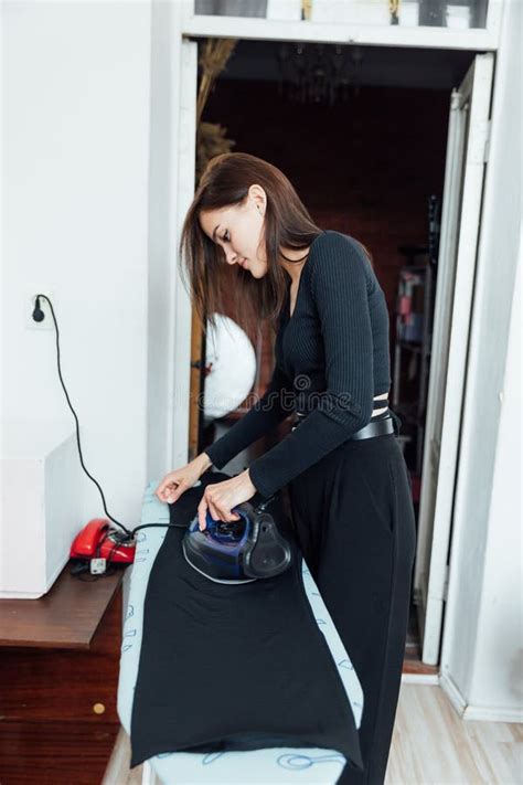 Brunette Woman Ironing Things On Ironing Board At Home Stock Photo Image Of Cleanliness