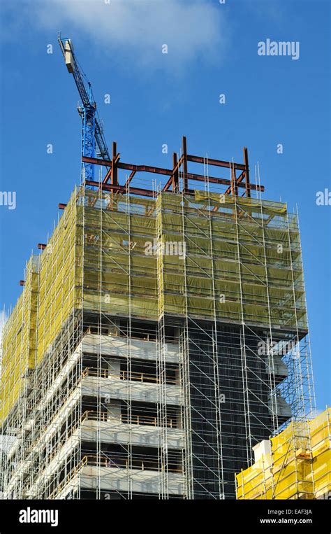 Construction Site Of Tall Administration Building With Crane